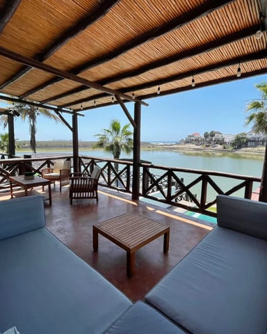 Covered terrace with lounge seating overlooking the lagoon at Nuevo Altata